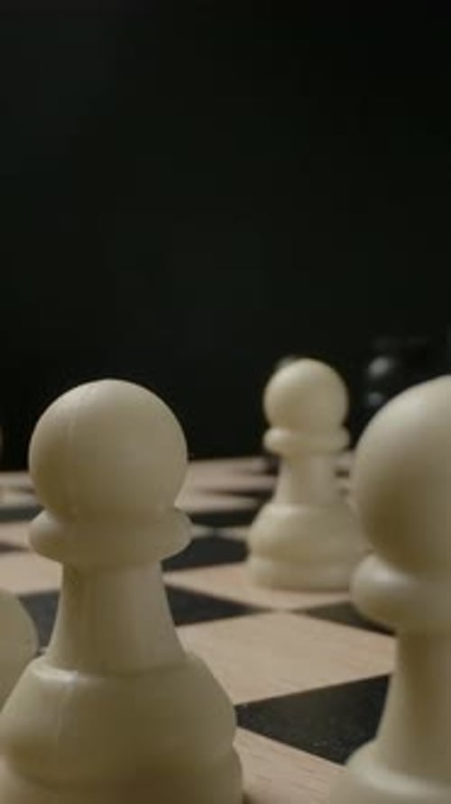 Vertical of Man's Hand Moving Chess Figure Knight From First Line Macro Shot of Small Plastic Chess