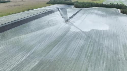 Sprinkler Irrigation System Watering Farm Field During Dry Season Spraying Water on Farmland Ground