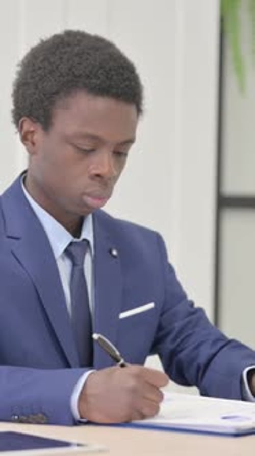 African Businessman Doing Paperwork in Office, Vertical Video