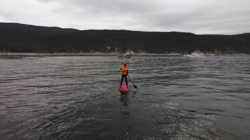 Man Paddling on a Stand Up Paddle Board in the Water