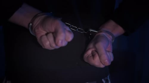 Close Up of Hands Cuffed Behind Back