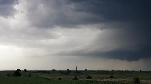 Storm Clouds and Lightning Over Rolling Green Fields