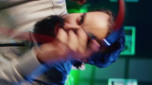Vertical Video Close Up on Pro Gamer Playing Videogame Teaching Viewers Esports Strategies