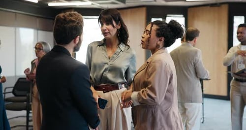 Business colleagues talk in a corporate meeting room