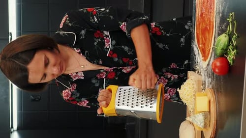 Woman Grating Cheese to Prepare Delicious Pizza