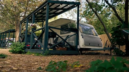 A mobile home with a terrace is located in country glamping site for relaxation and solitude nature