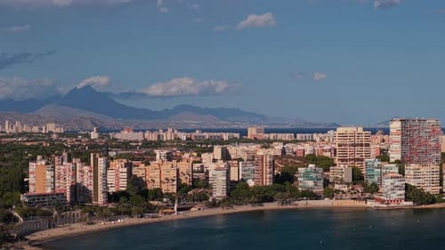 Aerial View of Alicante Coastline with Albufereta Beach Residential Buildings and Mountains in the