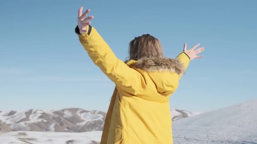 Woman Stand on Mountain Top with Hands Up on Sunset Sky