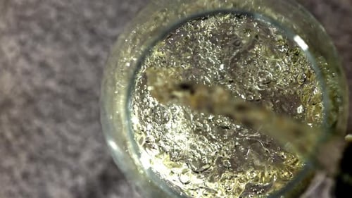 White Wine is Poured Into a Glass Filmed on a Highspeed Camera at 1000 Fps