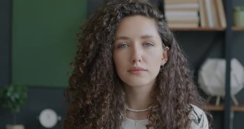 Slow Motion Portrait of Confident Businesswoman Looking at Camera Indoors in Workplace