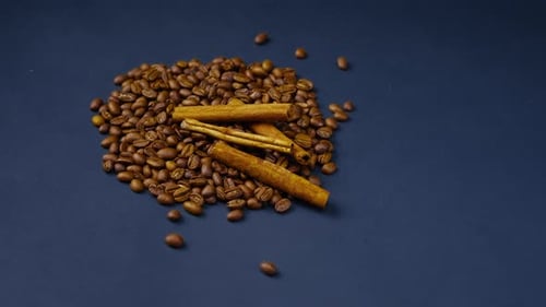 Top Shot Closeup on a Black and Blue Background Roasted Coffee Beans Lie Laid Out on a Background