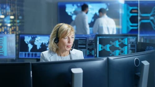 System Monitoring Room Female Dispatcher Control Correct Functioning of the System. In the Backgrou