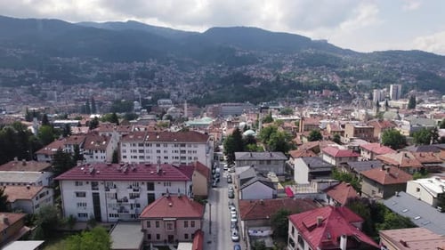 Aerial: Sarajevo cityscape, Bosnia and Herzegovina with mountain backdrop