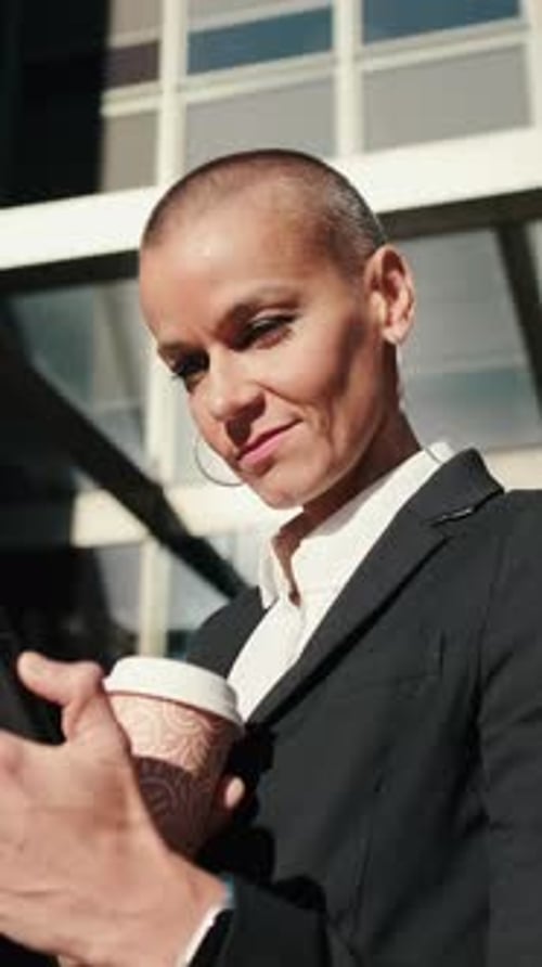 Vertical video, Businesswoman Using Phone Outside Office Building