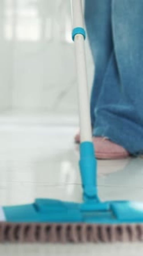 Woman Cleaning Bathroom Floor