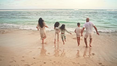 Happy Family of Adult People and Children Running to Sea Water of Ocean Beach