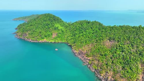 Aerial view reveals a paradise island with lush rainforests in Thailand.