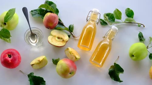 Overhead Still Life of Fresh Apples and Cider Bottles