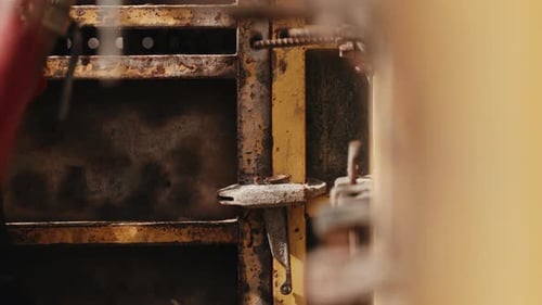 Worker Hammering Formwork Fastener During Concrete Wall Assembly