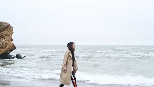 Close Up Portrait of Attractive Brunette Woman Walking on the Autumn Beach
