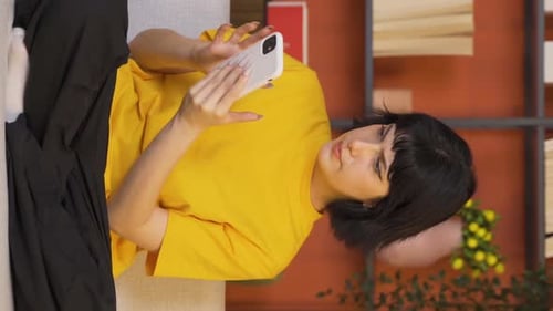 Woman Using Mobile Phone While Lying on Sofa