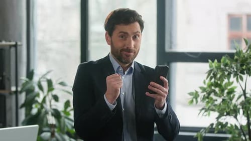 Happy Caucasian Man Businessman Entrepreneur Male Manager Winner Reading Good News on Phone in