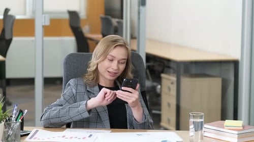 Office Worker Using Smartphone at Office