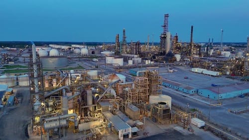 Cenovus Toledo Oil Refinery illuminated at dusk with storage tanks and towers in Toledo, Ohio, USA