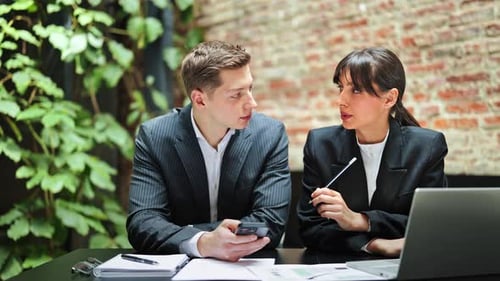 Business Colleagues in Formal Suits Discuss Work at the Office