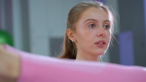 Focused Gym Instructor Guides Leg Exercise with Blue Converse