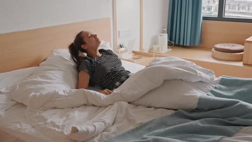 Woman in Bed Waking Up and Sitting Upright
