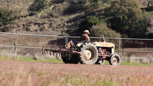 Vintage Tractor Tilling Field in the Countryside