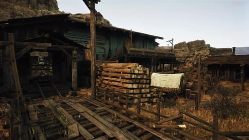 A Dilapidated Building with a Pile of Wood in the Foreground