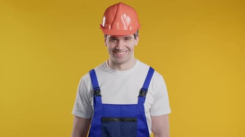 Freundlicher Handwerker zeigt Ja-Signal nickt mit dem Kopf, stimmt positiv lächelnder Baumeister zu
