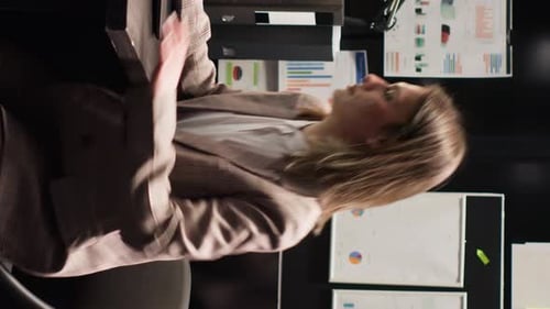 Woman Reviews Documents in Corporate Office Environment