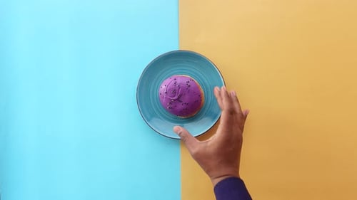 Top View of Hand Pick a Chocolate Donuts From a Plate