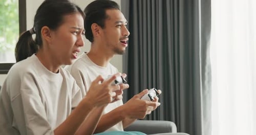 Couple Playing a Video Game at Home