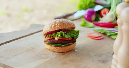 Vegan Burger with Fresh Vegetables on Wooden Table