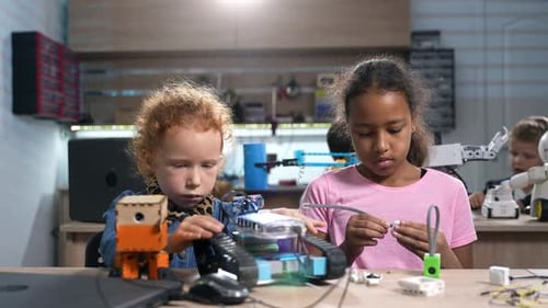 Diverse Elementary School Girls Work on Robotics