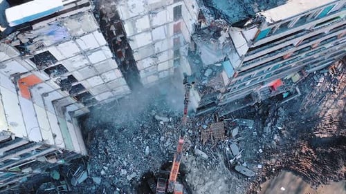 Construction of destroyed house. Destructive demolition building by excavator.