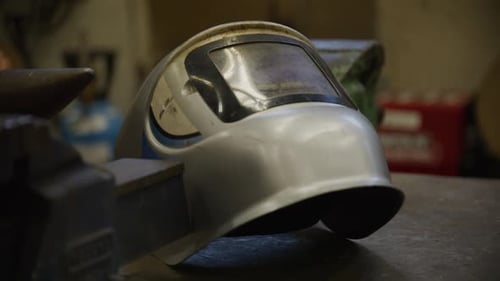 Welding mask on a welding table in a classroom