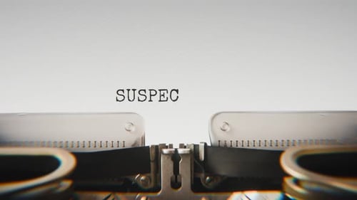 Old mechanical typewriter typing Suspect Identified in a close-up view.