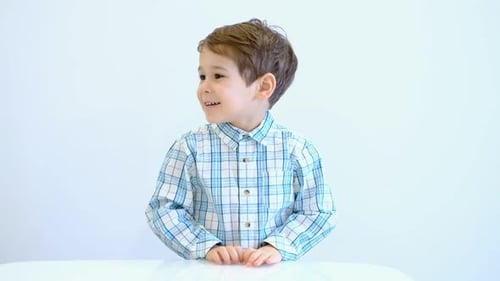 Smiling Child Clapping and Holding Hands Together