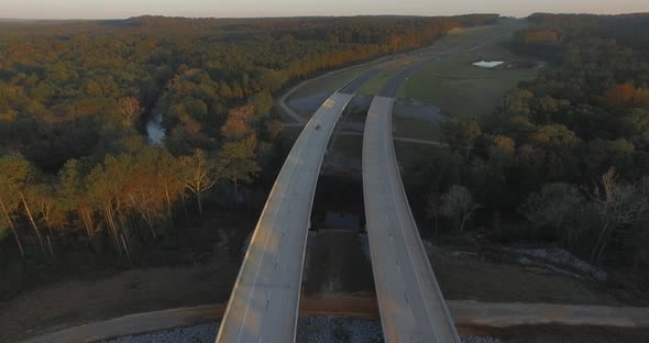 Cars driving on rural two lane road bridge over small creek., Vehicles ...