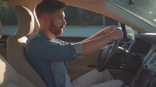 Bearded Man Driving a Car in the City