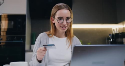 Woman using bank credit card for shopping in an online store. Young beautiful blond girl with ease