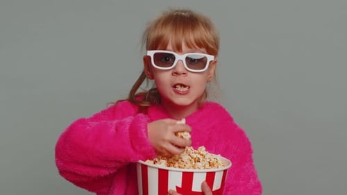 Girl in 3D Glasses Eats Popcorn