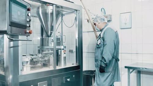 Machine operator working on pharmaceutical production line