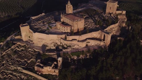 Aerial view of medieval castle and fortress with olive groves, Spain.