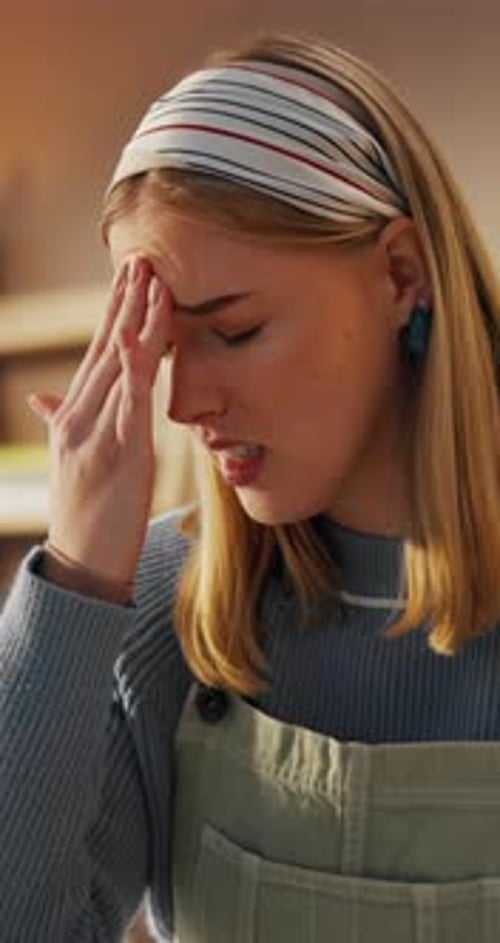 Woman, student and headache with stress in home, exhausted and tired for burnout with pain